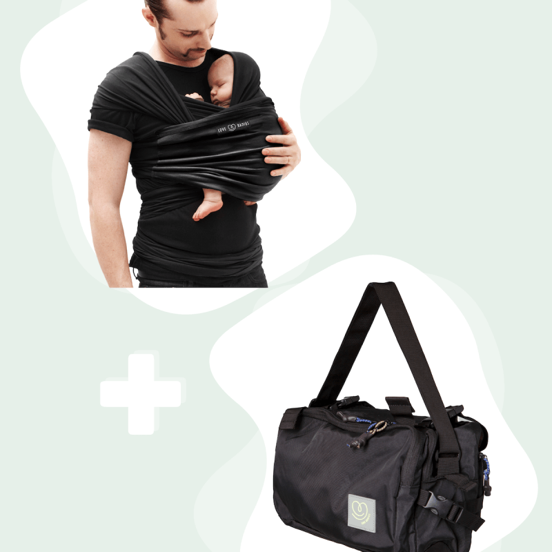 Vater trägt Baby in schwarzem Love Radius Tragetuch mit schwarzer CaravanBAG Wickeltasche