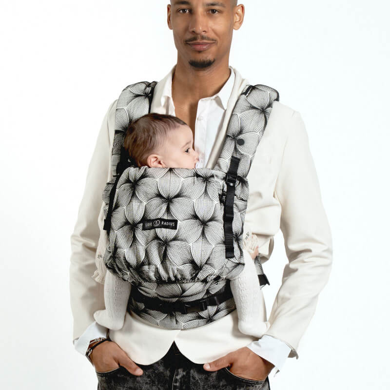 Marsupio Love Radius PhysioCarrier 2 Black Orchid indossato da un padre rivolto verso la fotocamera