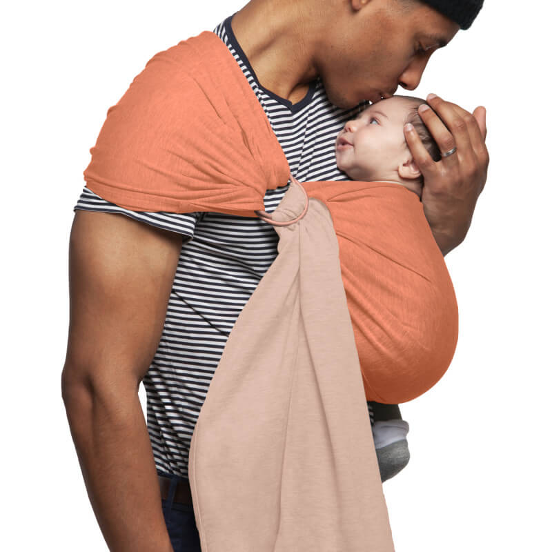 Father carrying baby in Love Radius reversible nude caramel sling, side view