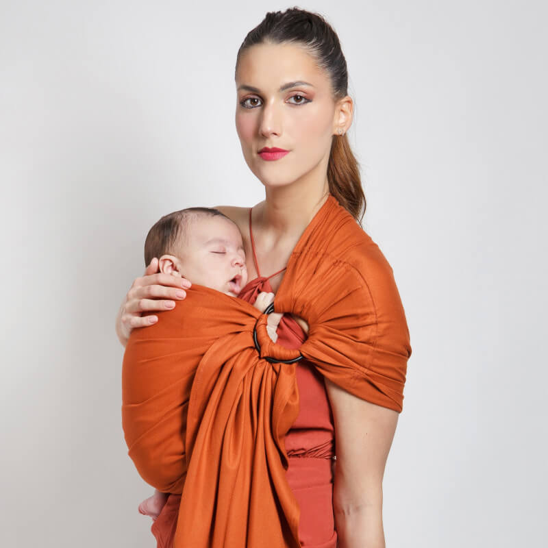 Mutter trägt schlafendes Baby in Love Radius Tragetuch in Wildfarbe